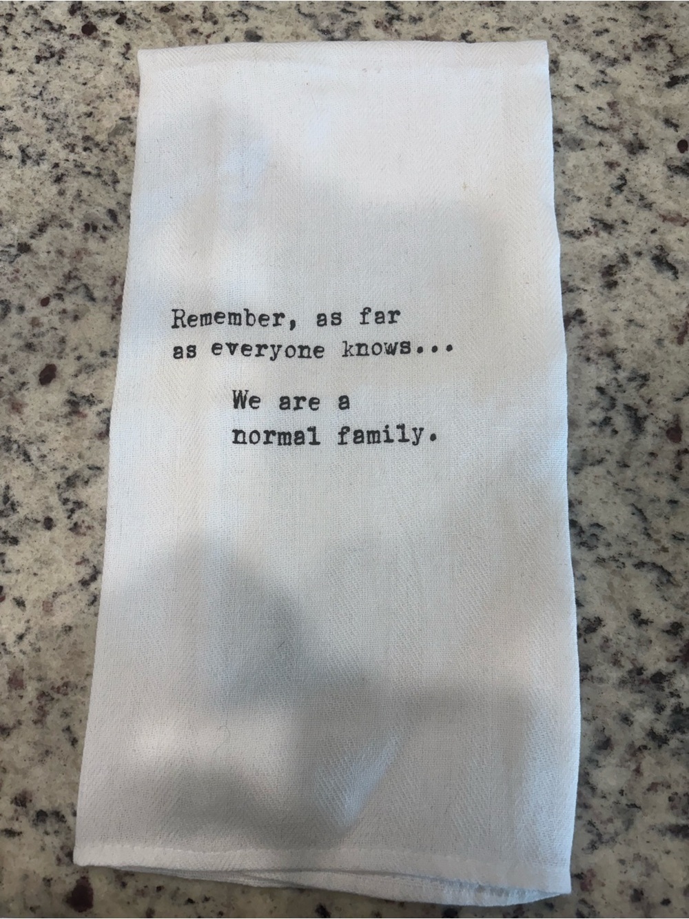 White Tea Towel with 'We Are a Normal Family' Quote